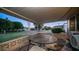 Relaxing covered patio with outdoor seating and views of the well-maintained lawn at 9523 W Sandstone Dr, Sun City, AZ 85351