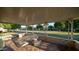 Inviting covered patio with tiled flooring, wrought iron furniture, and a view of the lush lawn at 9523 W Sandstone Dr, Sun City, AZ 85351