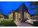 Backyard patio at dusk with a built-in pool, stone columns, and outdoor seating at 10040 E Happy Valley Rd # 269, Scottsdale, AZ 85255