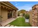 Backyard featuring a built-in grill, lush green lawn, and well-maintained landscaping with mountain views at 10040 E Happy Valley Rd # 269, Scottsdale, AZ 85255