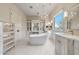 Luxurious bathroom featuring a standalone tub, crystal chandelier, vanity, and ample storage at 10040 E Happy Valley Rd # 269, Scottsdale, AZ 85255