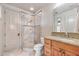 Well-lit bathroom featuring a glass-enclosed shower, vanity with granite countertop, and elegant fixtures at 10040 E Happy Valley Rd # 269, Scottsdale, AZ 85255