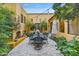 Charming courtyard with outdoor dining, lush greenery, a fireplace, and string lights for ambiance at 10040 E Happy Valley Rd # 269, Scottsdale, AZ 85255