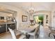 Elegant dining room featuring a chandelier and access to the outdoor patio at 10040 E Happy Valley Rd # 269, Scottsdale, AZ 85255