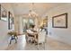 Charming dining room with light wood floors and bright natural light from the French doors at 10040 E Happy Valley Rd # 269, Scottsdale, AZ 85255