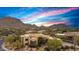 Exterior view with a colorful sky backdrop showcases the desert landscaping and views at 10040 E Happy Valley Rd # 269, Scottsdale, AZ 85255