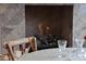 Close up of fireplace and a side table and chairs at 10040 E Happy Valley Rd # 269, Scottsdale, AZ 85255