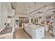 Gourmet kitchen with white cabinets, large island, stainless appliances and open to the living area at 10040 E Happy Valley Rd # 269, Scottsdale, AZ 85255