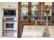 Kitchen features stainless steel appliances, white marble countertops, custom cabinets and sink at 10040 E Happy Valley Rd # 269, Scottsdale, AZ 85255