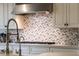 Kitchen showcases decorative tile backsplash, light countertops, stainless steel fixtures and modern hood at 10040 E Happy Valley Rd # 269, Scottsdale, AZ 85255