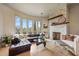Comfortable living room boasting stone fireplace, hardwood floors, and plentiful sunlight at 10040 E Happy Valley Rd # 269, Scottsdale, AZ 85255
