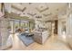 Expansive living space with a stone fireplace, coffered ceilings and view of the kitchen at 10040 E Happy Valley Rd # 269, Scottsdale, AZ 85255