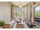 Elegant living room with bright bay window, patterned wallpaper, chandelier, and neutral furniture at 10040 E Happy Valley Rd # 269, Scottsdale, AZ 85255