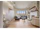 Cozy living room with stone fireplace, hardwood floors, and large windows at 10040 E Happy Valley Rd # 269, Scottsdale, AZ 85255