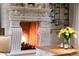 Detail of the stone fireplace with a horse statue on the mantle in the living room at 10040 E Happy Valley Rd # 269, Scottsdale, AZ 85255