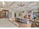Bright and airy living room featuring coffered ceilings, a stone fireplace, and seamless flow to the kitchen at 10040 E Happy Valley Rd # 269, Scottsdale, AZ 85255