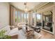 Bright living room with view to outdoor patio, neutral furniture, statement chandelier, and hardwood floors at 10040 E Happy Valley Rd # 269, Scottsdale, AZ 85255