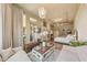 Open concept living space featuring living area, bedroom, outdoor views, and decorative chandelier at 10040 E Happy Valley Rd # 269, Scottsdale, AZ 85255