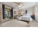 Serene main bedroom with plush carpeting, access to a private patio, and a ceiling fan for added comfort at 10040 E Happy Valley Rd # 269, Scottsdale, AZ 85255