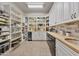 Spacious pantry boasts white cabinets, shelves, butcher block countertop and beverage cooler at 10040 E Happy Valley Rd # 269, Scottsdale, AZ 85255