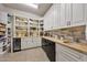 Pantry features white cabinets, wine cooler, wood countertop, tile backsplash, and tiled flooring at 10040 E Happy Valley Rd # 269, Scottsdale, AZ 85255