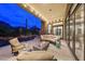 Relaxing covered patio with comfortable seating, a modern fire pit, and views of the pool and desert scenery at 10040 E Happy Valley Rd # 269, Scottsdale, AZ 85255