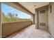 Covered patio with textured flooring, offering outdoor access with a view of the surrounding greenery at 10040 E Happy Valley Rd # 269, Scottsdale, AZ 85255