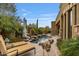 Stunning backyard pool with rock features and lush landscaping perfect for relaxation at 10040 E Happy Valley Rd # 269, Scottsdale, AZ 85255