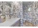 Unique powder room with patterned wallpaper, contemporary fixtures, and a vessel sink at 10040 E Happy Valley Rd # 269, Scottsdale, AZ 85255