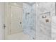 Elegant walk-in shower featuring marble-style tile, a glass door, and modern fixtures at 10040 E Happy Valley Rd # 269, Scottsdale, AZ 85255