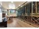 Spacious wine cellar with glass enclosure, fireplace, and a table for tastings at 10040 E Happy Valley Rd # 269, Scottsdale, AZ 85255