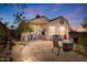 Outdoor living space with stone patio, comfortable seating, a ceiling fan, and mature landscaping at 10134 E Meandering Trail Ln, Gold Canyon, AZ 85118