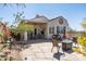 Backyard with a stone patio, fire pit, covered patio, desert landscaping and mountain views at 10134 E Meandering Trail Ln, Gold Canyon, AZ 85118