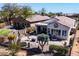 A bird's eye view of a landscaped backyard with a patio, outdoor furniture and mature desert plants at 10134 E Meandering Trail Ln, Gold Canyon, AZ 85118