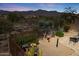 Expansive backyard with desert landscaping, decorative lighting, and mountain views in the distance at 10134 E Meandering Trail Ln, Gold Canyon, AZ 85118