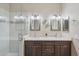 Well lit dual sink bathroom with granite countertops, modern fixtures, a walk-in glass shower and tiled walls at 10134 E Meandering Trail Ln, Gold Canyon, AZ 85118