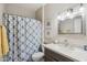 Bathroom features a marble-top vanity and tub-shower combo with patterned shower curtain at 10134 E Meandering Trail Ln, Gold Canyon, AZ 85118