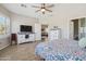 Spacious main bedroom with laminate floors, ceiling fan and a view overlooking the living room at 10134 E Meandering Trail Ln, Gold Canyon, AZ 85118