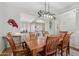 Cozy dining room area with wood table set and decorative lighting fixture overlooking the kitchen at 10134 E Meandering Trail Ln, Gold Canyon, AZ 85118