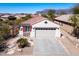 Charming single-story home featuring a red tile roof, neutral stucco, and a well-manicured desert landscape at 10134 E Meandering Trail Ln, Gold Canyon, AZ 85118