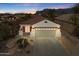 Charming home showcasing its facade, garage, desert landscaping, and mountain views in the background at 10134 E Meandering Trail Ln, Gold Canyon, AZ 85118