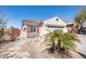 Single-story house with desert landscaping, neutral stucco, red shutters and a terracotta tile roof at 10134 E Meandering Trail Ln, Gold Canyon, AZ 85118