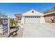 Charming single-story home with desert landscaping, a tile roof, and attached two-car garage at 10134 E Meandering Trail Ln, Gold Canyon, AZ 85118