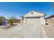 Inviting single-level home with a wide driveway, xeriscaping, and a well-maintained front yard at 10134 E Meandering Trail Ln, Gold Canyon, AZ 85118