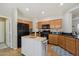 Well-equipped kitchen with stainless appliances, wood cabinetry, central island, and tiled flooring at 10134 E Meandering Trail Ln, Gold Canyon, AZ 85118