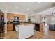 Open kitchen boasts wood cabinets, a movable island, and black appliances, offering plenty of counter space at 10134 E Meandering Trail Ln, Gold Canyon, AZ 85118
