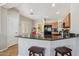 Modern kitchen features granite counters, stainless steel appliances, and a convenient breakfast bar with seating at 10134 E Meandering Trail Ln, Gold Canyon, AZ 85118