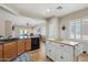 Spacious kitchen with granite countertops, an island prep area, and a breakfast bar overlooking the living room at 10134 E Meandering Trail Ln, Gold Canyon, AZ 85118