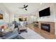 Open-concept living space featuring a fireplace, comfortable seating, and a view of the kitchen at 10134 E Meandering Trail Ln, Gold Canyon, AZ 85118