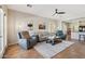 Spacious living area with comfortable seating, ceiling fan, and a view to the kitchen at 10134 E Meandering Trail Ln, Gold Canyon, AZ 85118